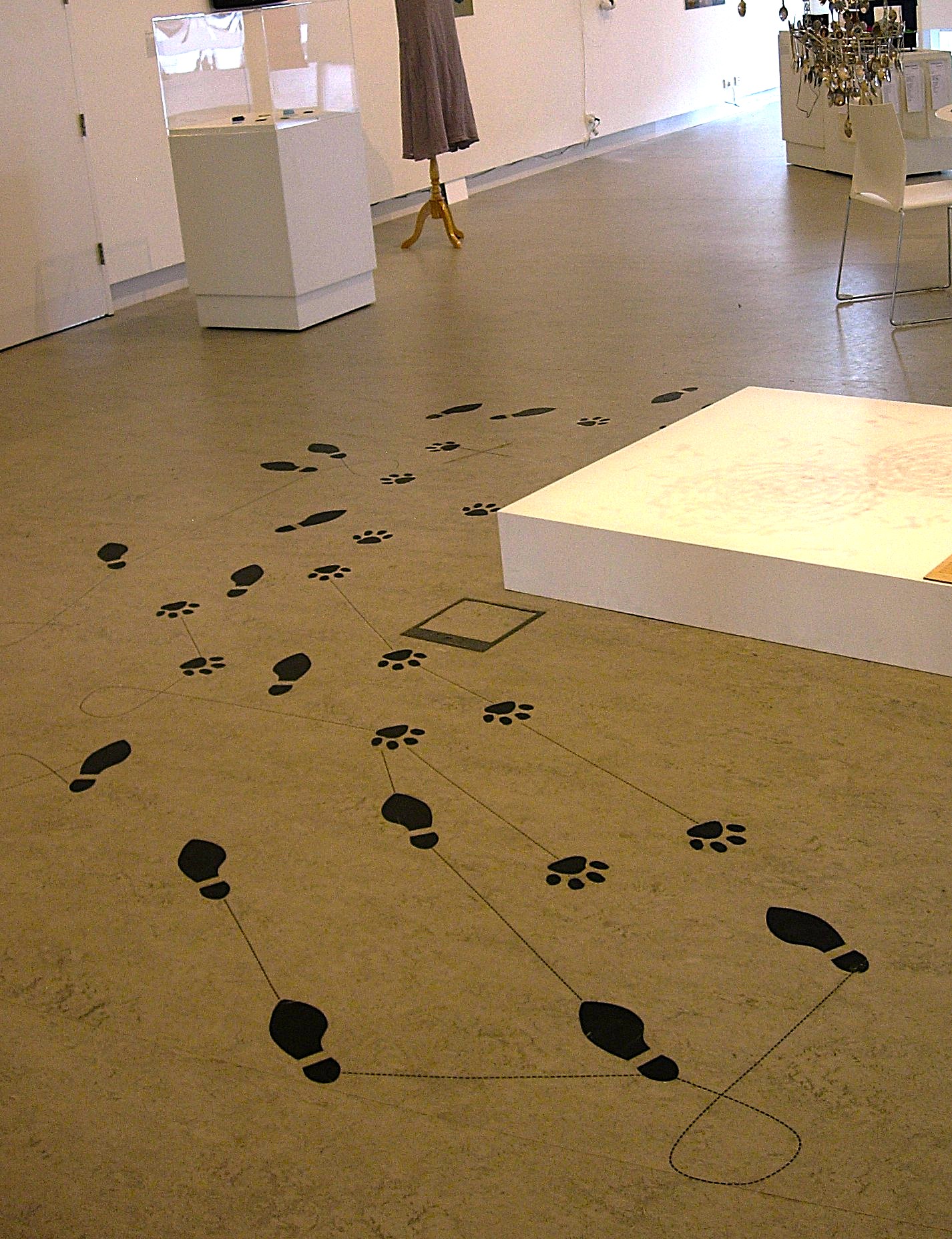 Gallery installation with footprints and pedestals