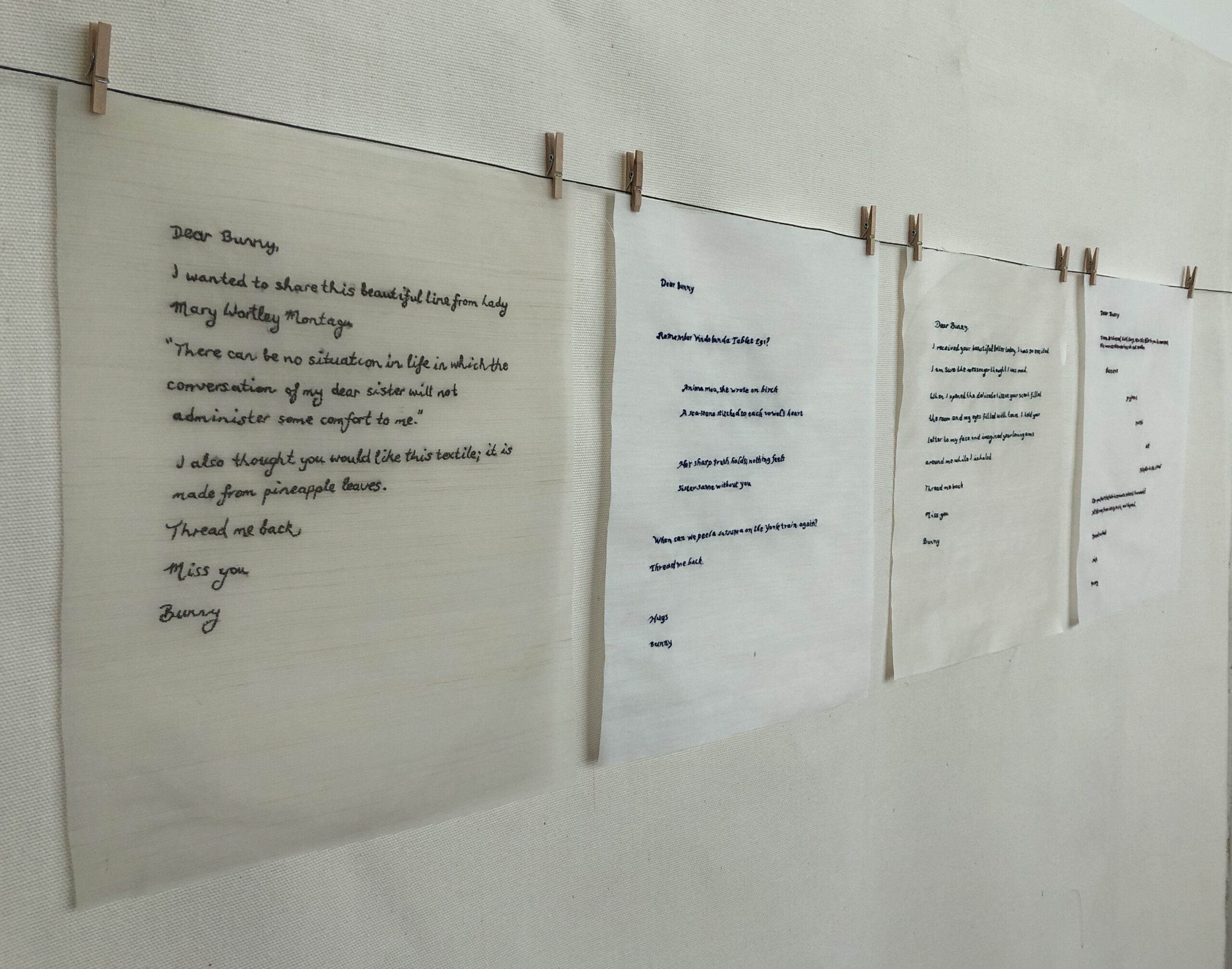 Handwritten letters hanging on clothesline